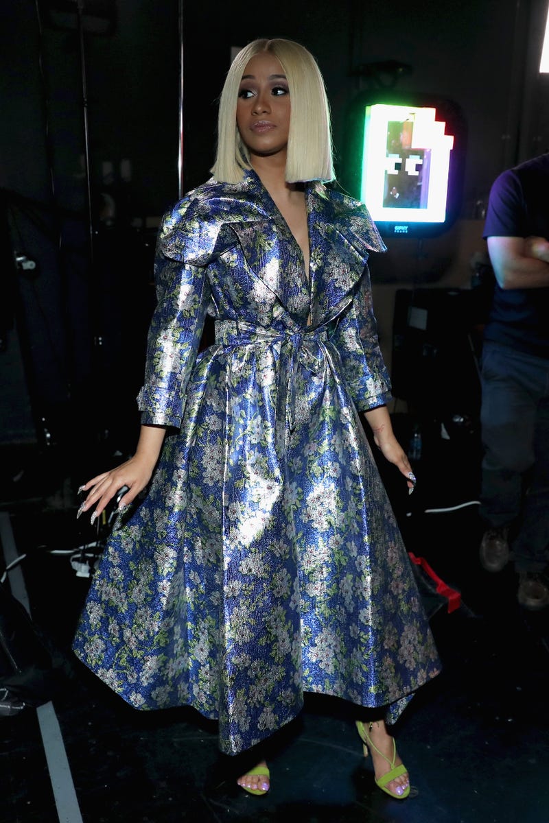 cardi b looking sleuthy in her floral trenchcoat dress at the 2017 bet awards