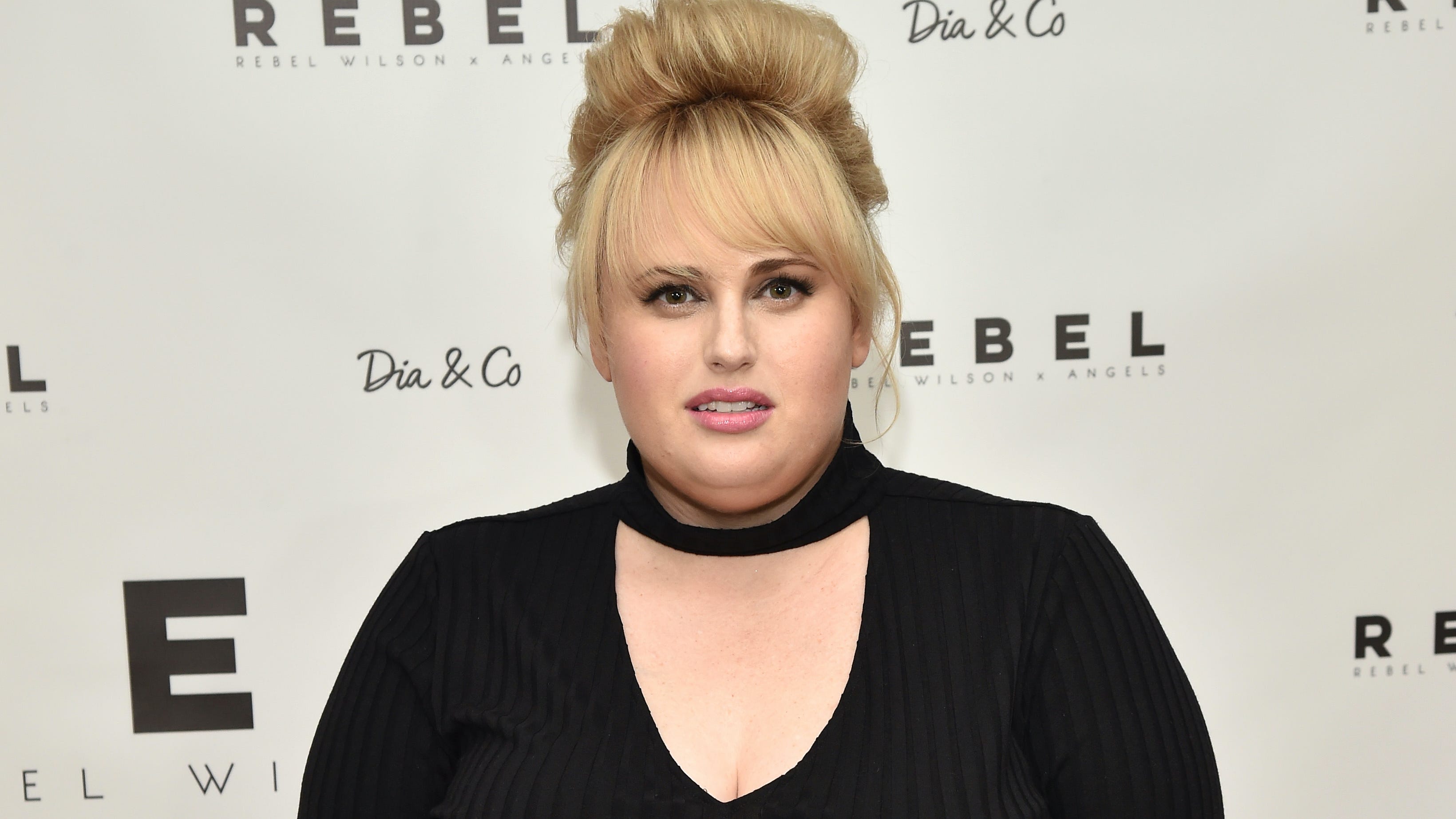 Rebel Wilson stuns on the beach in figure-hugging wetsuit