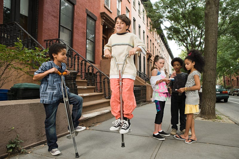 Kids jumping on pogo sticks.