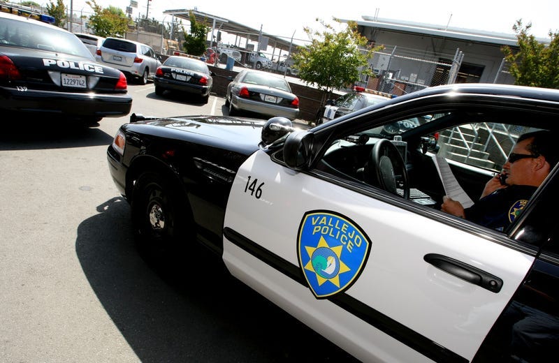 Vallejo Police Department Corporal John Garcia talks on the phone and goes over paperwork in his patrol car as he gets ready to patrol the streets May 7, 2008 in Vallejo, California.