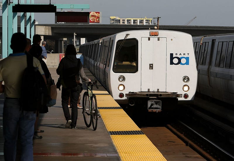 Bay Area Rapid Transit (BART) passengers stand on the platform as a train pulls into the station May 12, 2008 in Oakland, California.