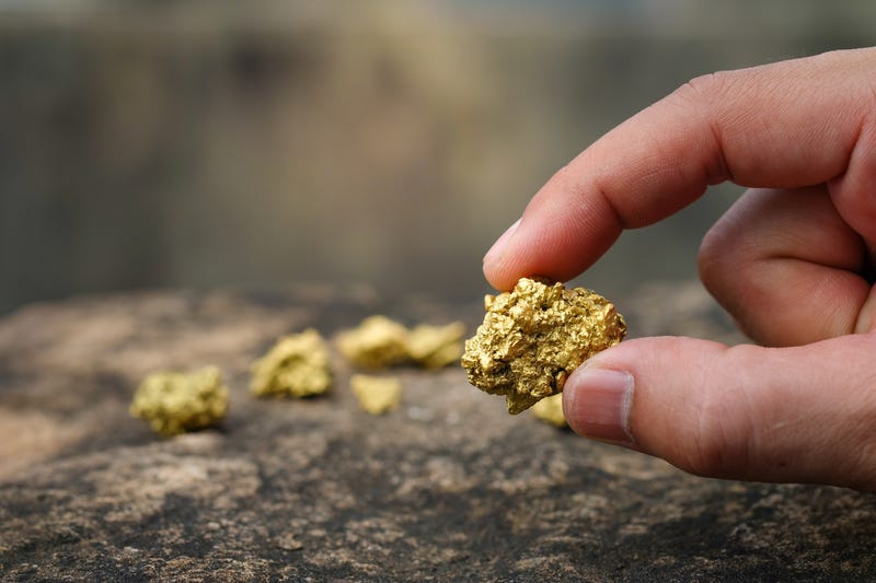 The pure gold ore found in the mine is in the hands of men