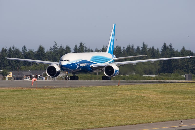 A Boeing 777 Freighter taxis up the runway.