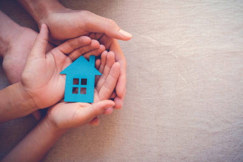 Family holding a home