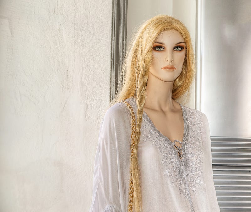 Blond Mannequin standing on display in a window