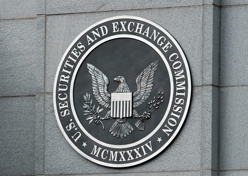 The U.S. Securities and Exchange Commission seal hangs on the facade of its building in Washington, DC. 