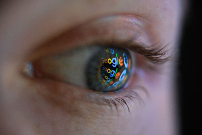 In this photo illustration, an image of the Google logo is reflected on the eye of a young man on August 09, 2017 in London, England. 