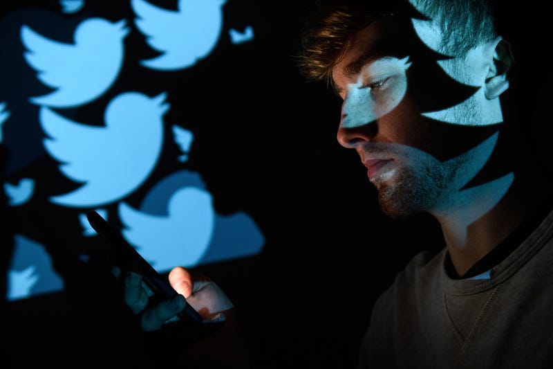 LONDON, ENGLAND - AUGUST 09: In this photo illustration, the logo for the Twitter social media network is projected onto a man on August 09, 2017 in London, England. With around 328 million users worldwide, Twitter has gone from a small start-up in for the public 2006 to a broadcast tool of politicians and corporations in 2017.