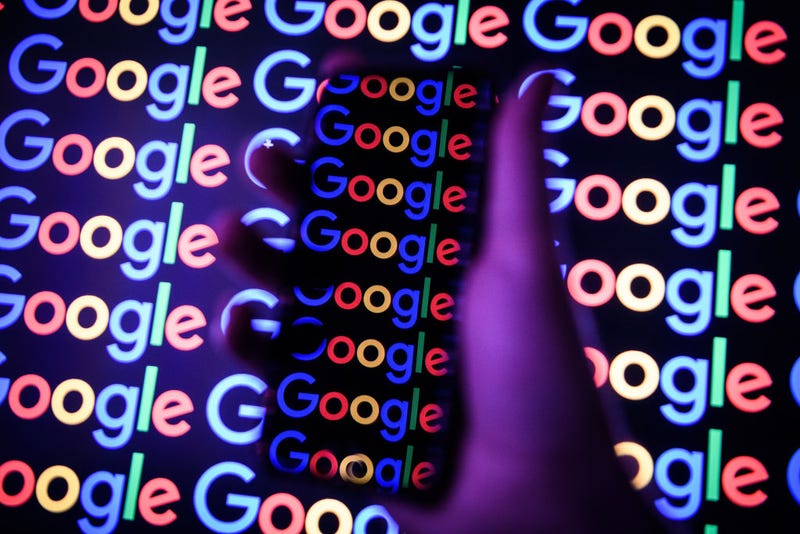 , The Google logo is displayed on a mobile phone and computer monitor on August 09, 2017 in London, England.