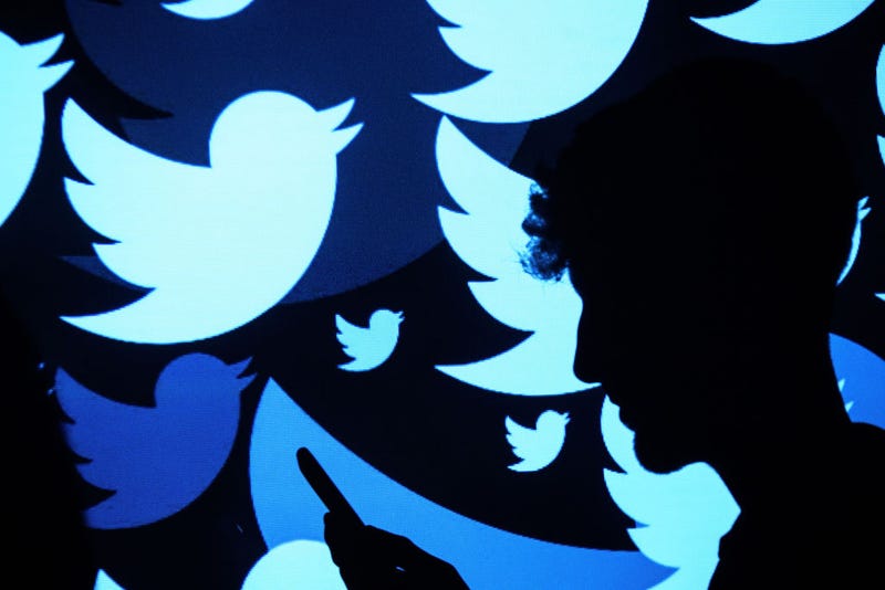 In this photo illustration, the logo for the Twitter social media network is projected onto a man on August 09, 2017 in London, England.