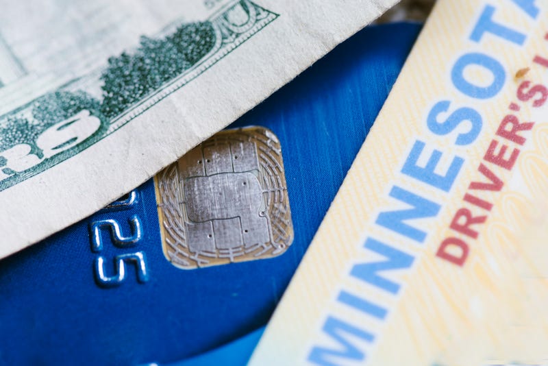 A Minnesota driver's license and money depicting the renewal process.