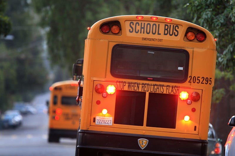School buses drive down teh road to pick up children before classes begin on October 10, 2008 in Pasadena, California.