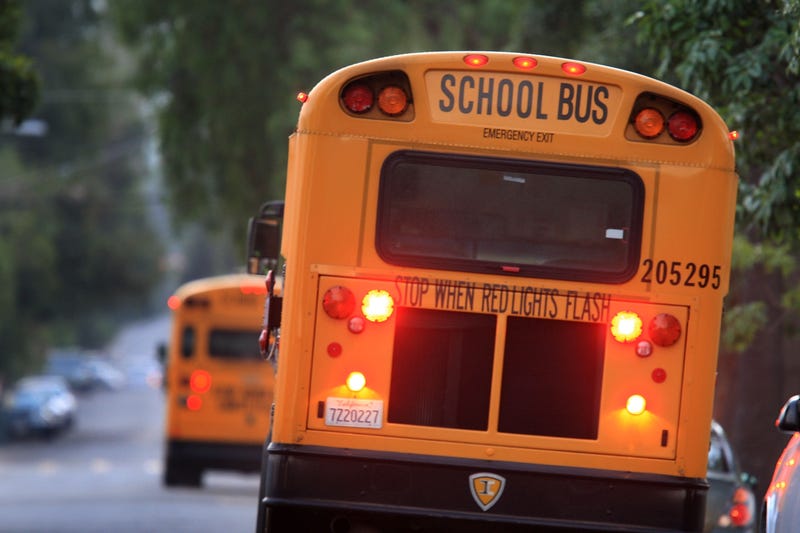 school bus with brake lights flashing