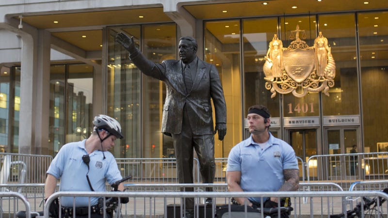 Police officers guard a statue of former Philadelphia mayor Frank Rizzo in front of the Municipal Services Building as protesters march against white supremacy Aug. 16, 2017 in Center City.