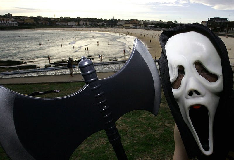 A young boy poses in a 'Scream' mask with an axe on Halloween in North Bondi on October 31, 2008 in Sydney, Australia.