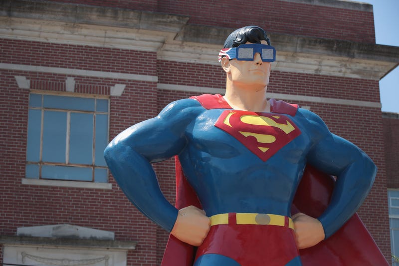 Superman statue with eclipse glasses