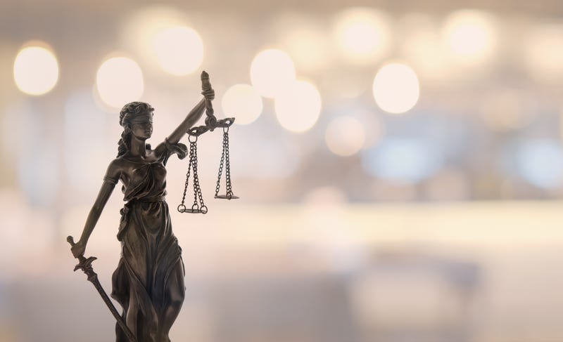 Statue of Justice or Lady Justice with blurred background.