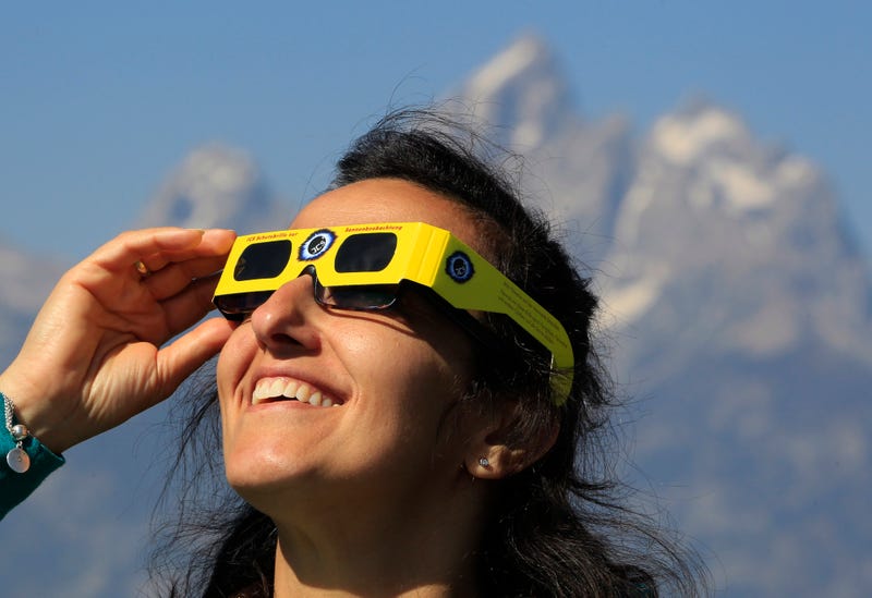 Woman using solar eclipse glasses
