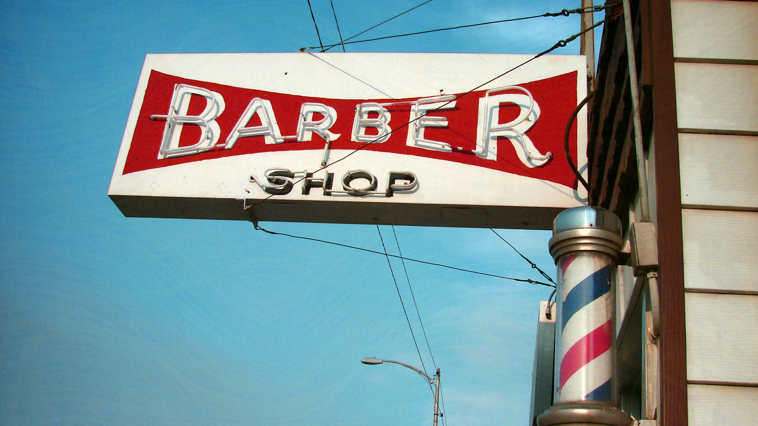 Why are barbershop poles red, white, and blue?