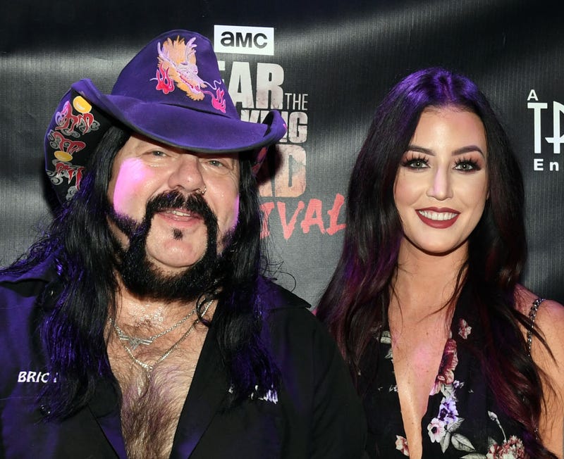 Recording artist Vinnie Paul (L) and Chelsey Yeager attend the Fear the Walking Dead Survival attraction grand opening at the Fremont Street Experience on August 29, 2017 in Las Vegas, Nevada.