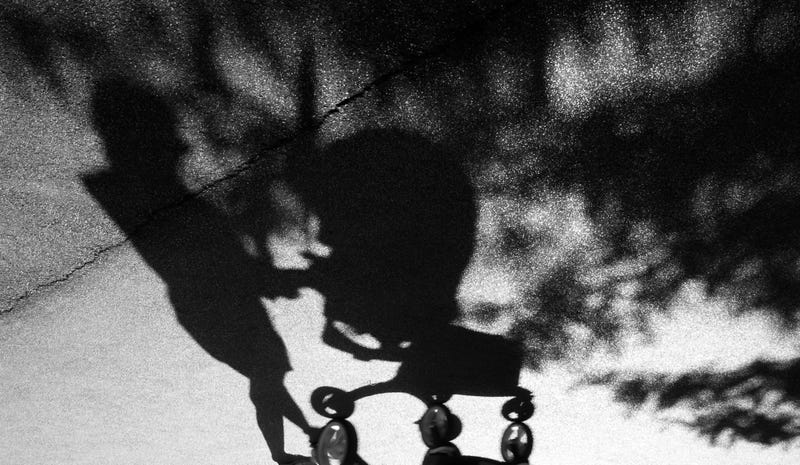 shadow of woman pushing stroller