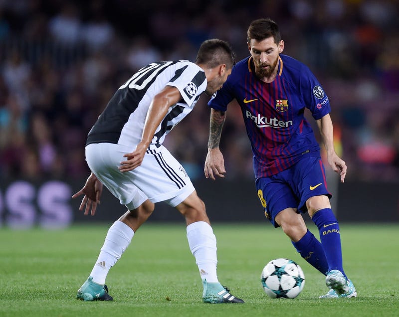 Lionel Messi of Barcelona attempts to get past Rodrigo Bentancur of Juventus during the UEFA Champions League Group D match between FC Barcelona and Juventus at Camp Nou on September 12, 2017 in Barcelona, Spain.