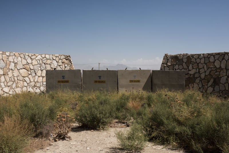 Remnants of dilapidated buildings sit at an unused section of Bagram Air Field 