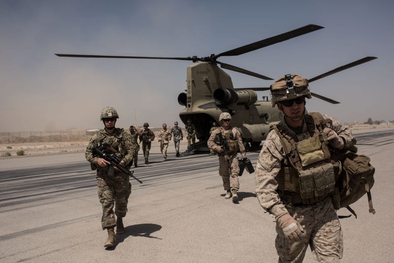 U.S. service members walk off a helicopter in Afghanistan.