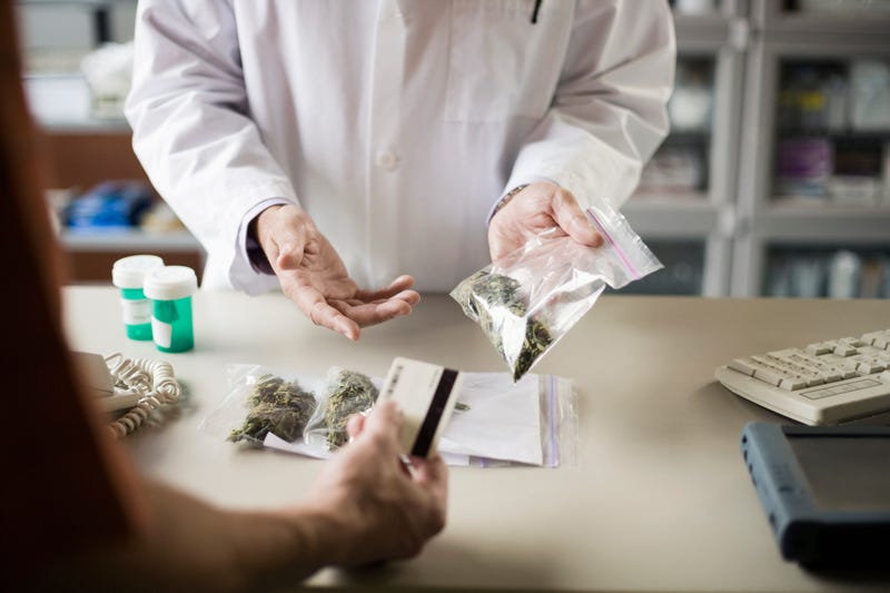stock image of a transaction at a weed dispensary