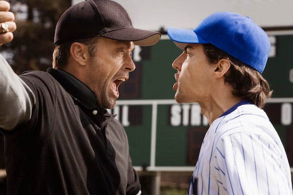 Baseball player and umpire arguing on the field