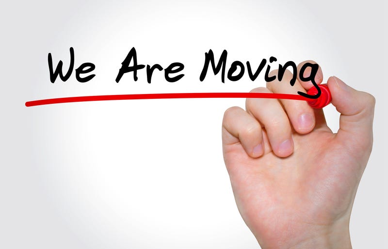 Hand writing inscription "We Are Moving" with marker
