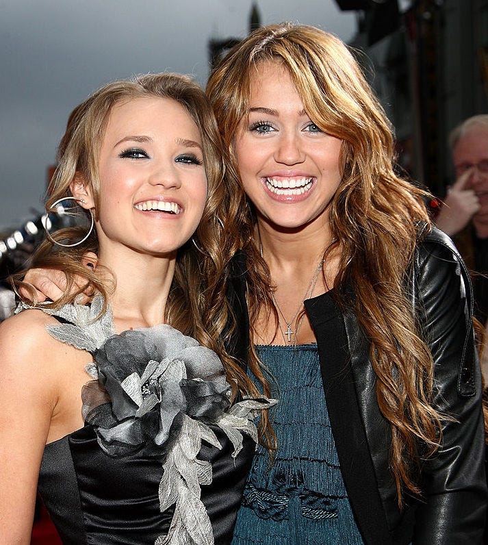 Emily Osment and actress/singer Miley Cyrus arrive at the premiere of Walt Disney Picture's 'Hannah Montana: The Movie'