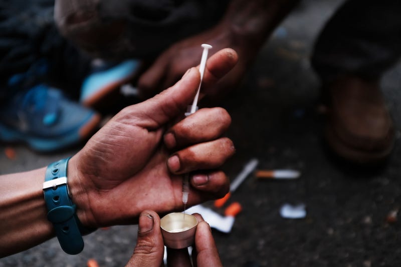 A heroin user prepares to shoot up on the street in a South Bronx neighborhood which has the highest rate of heroin-involved overdose deaths in the city on October 7, 2017 in New York City.