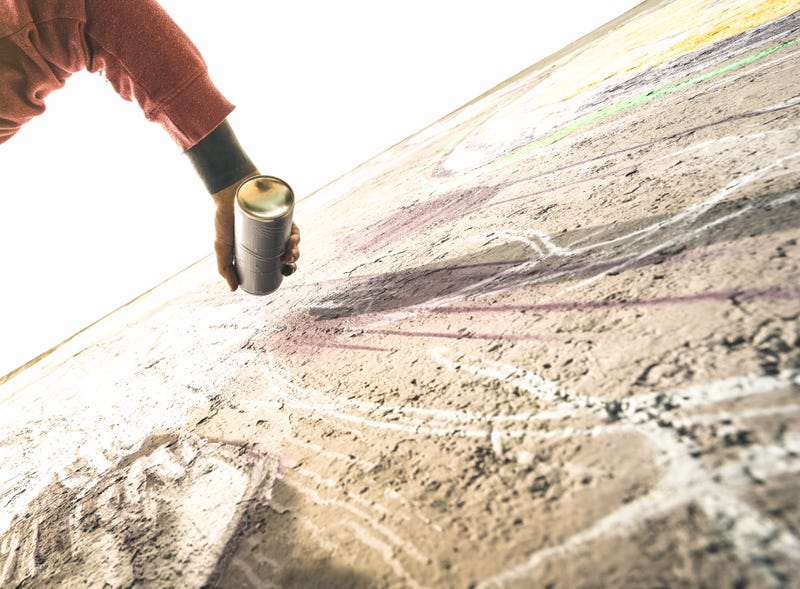 spray paint can and arts on wall