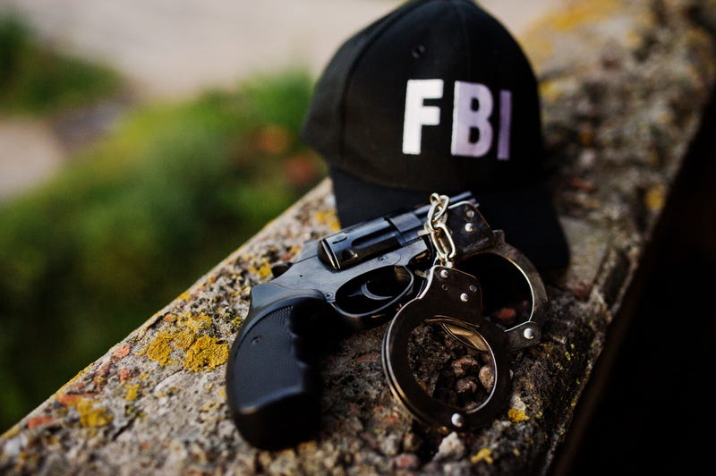 FBI cap with revolver and handcuffs