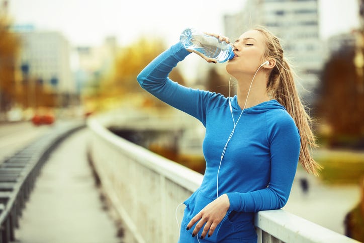 Woman Drinking Water And Exercising