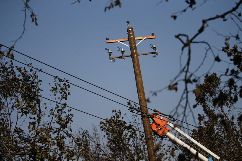 PG&E workers work to repair power lines in the Coffey Park neighborhood following the damage caused by the Tubbs Fire on October 13, 2017 in Santa Rosa, California.