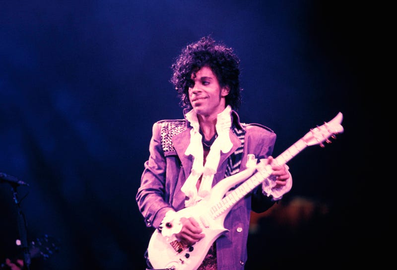 Prince performing on stage during the "Purple Rain Tour" in 1984.
