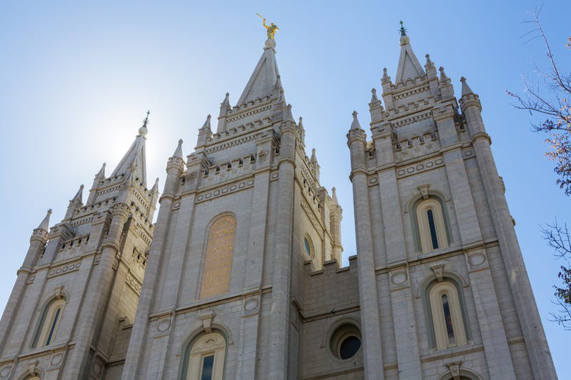 Salt Lake City LDS Mormon Temple spires with sun lighting it from behind.