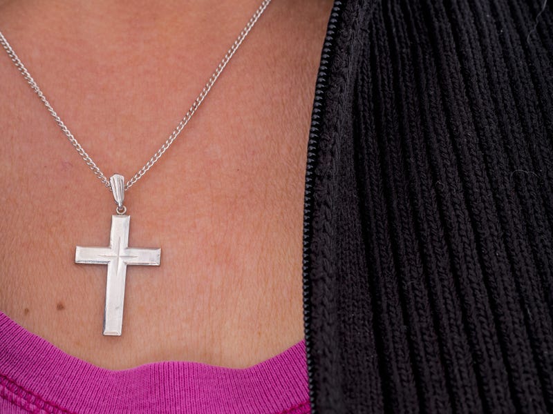 woman wearing cross necklace
