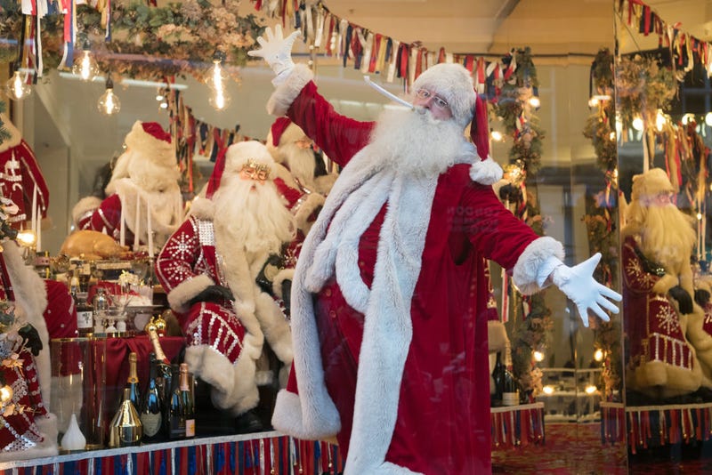 Santa poses for photographs next to a Christmas window display at Selfridges on October 19, 2017 in London, England.