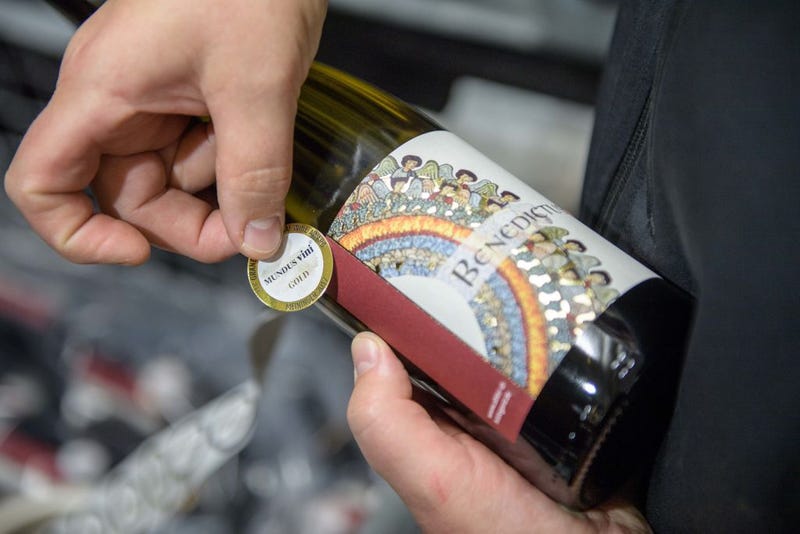 Nun Thekla of St. Hildegard Abbey labes wine bottels with an award label in the cellar on October 20, 2017 near Rudesheim on the Rhine, Germany.