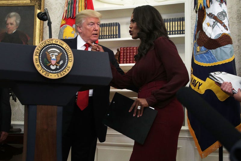 Former President Donald Trump listens to Director of Communications for the White House Public Liaison Office Omarosa Manigault during an event in the Oval Office of the White House October 24, 2017.
