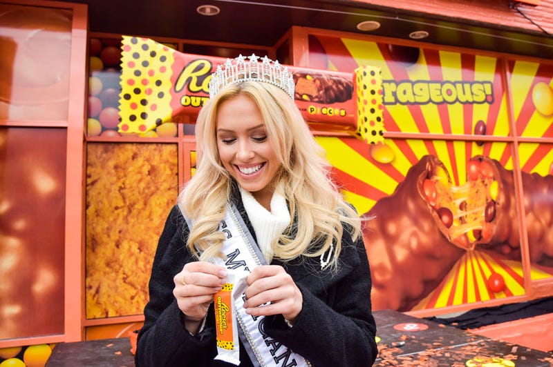 Elizabeth Johnson, 2018 Miss Michigan USA, enjoys one of the first, exclusive samples of new Reese's Outrageous Bars at Royal Oak, MichiganÕs annual Halloween Spooktacular on October 29, 2017.