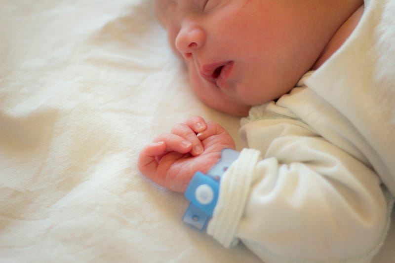 baby with hospital bracelet on