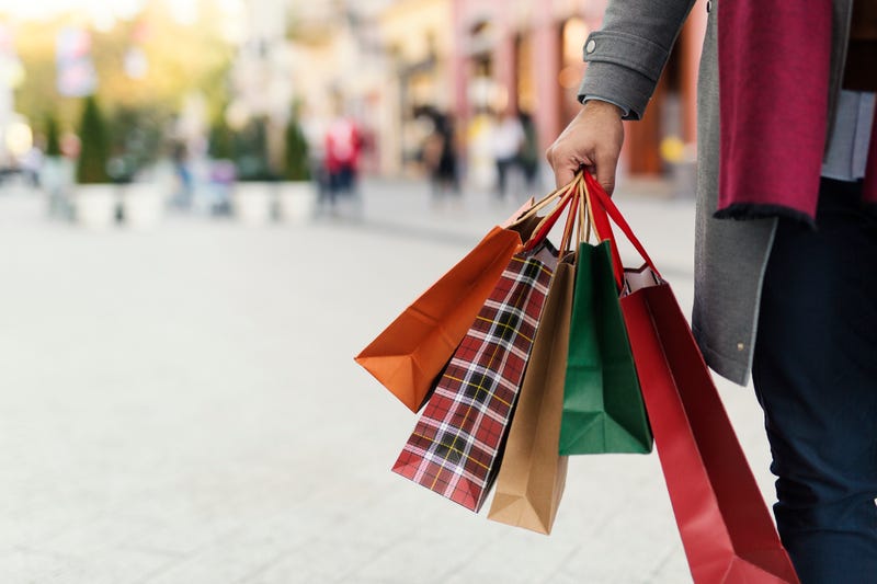 Person holding holiday shopping bags