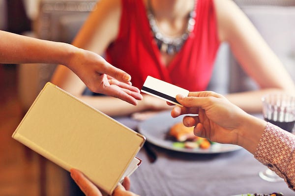 Man on a date paying with credit card