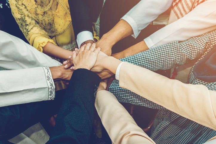 hands joining together to help