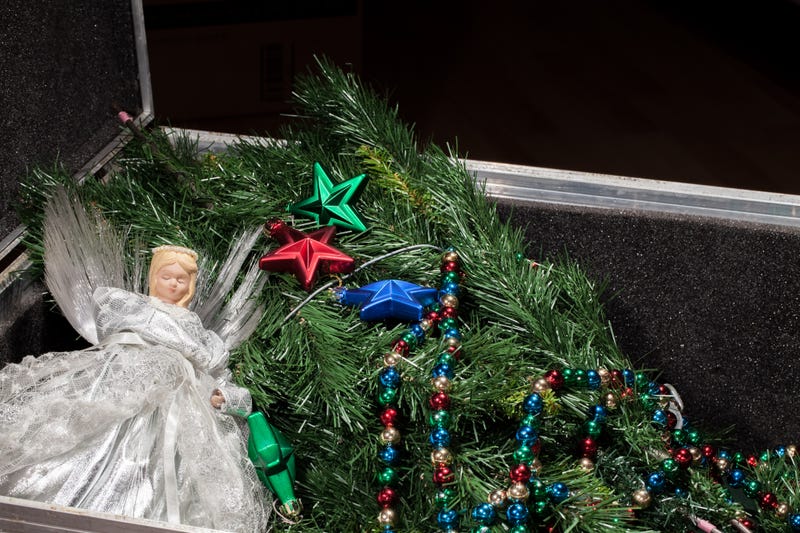 Time for Christmas decorations. Artificial xmas tree, fairy and star baubles in storage box ready for putting up. Festive season preparation.