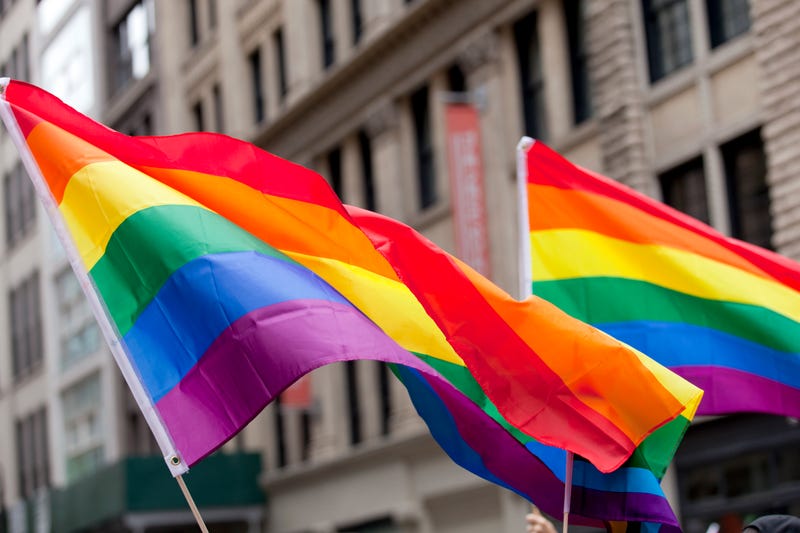 pride flags waving in front of building